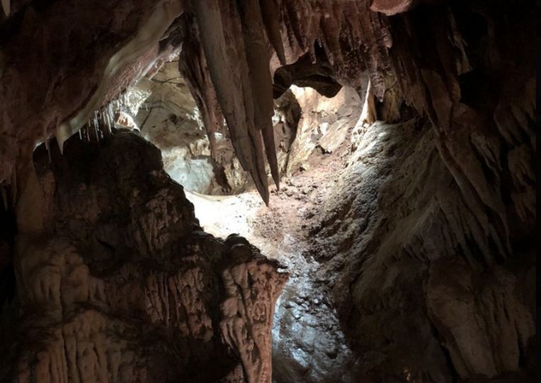 Stalactites hanging from cave ceiling